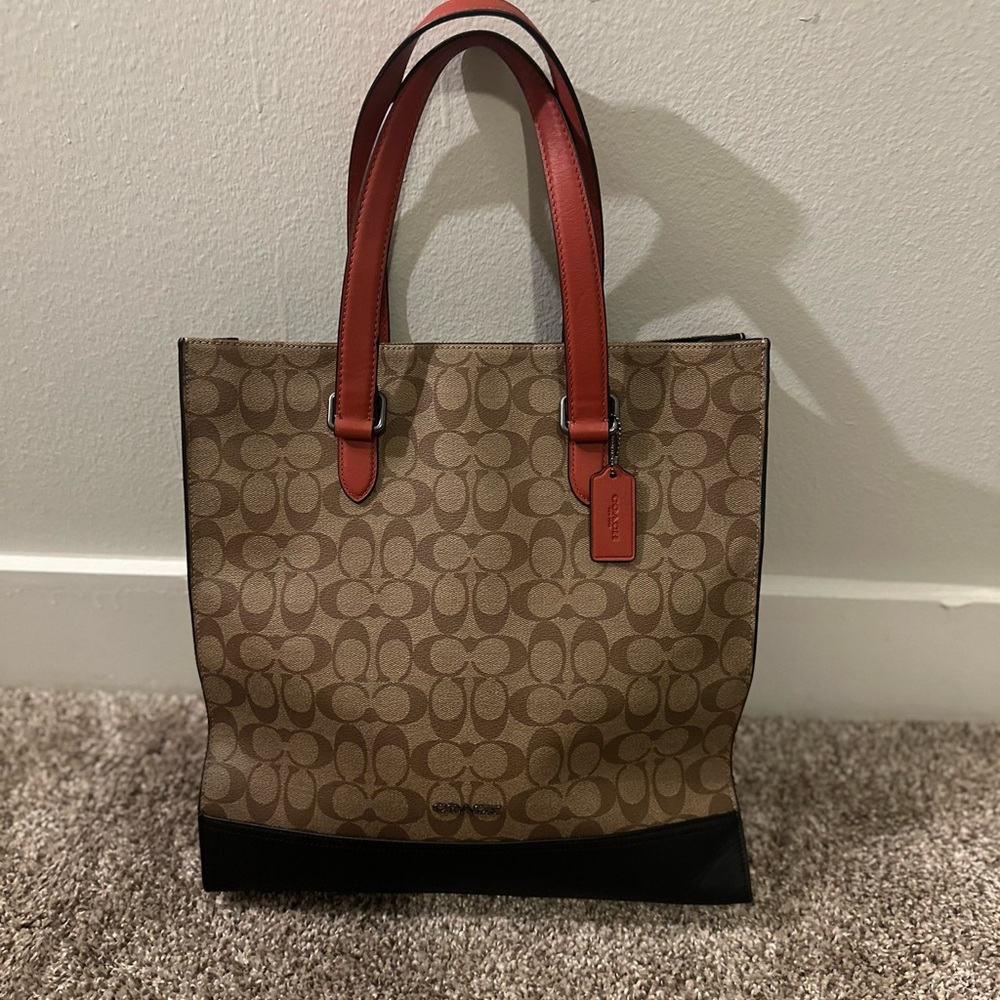 Coach brown bag with black bottom and orange handle